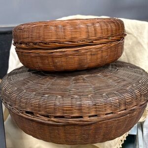 Antique Chinese woven wicker sewing baskets, often utilized for storage.